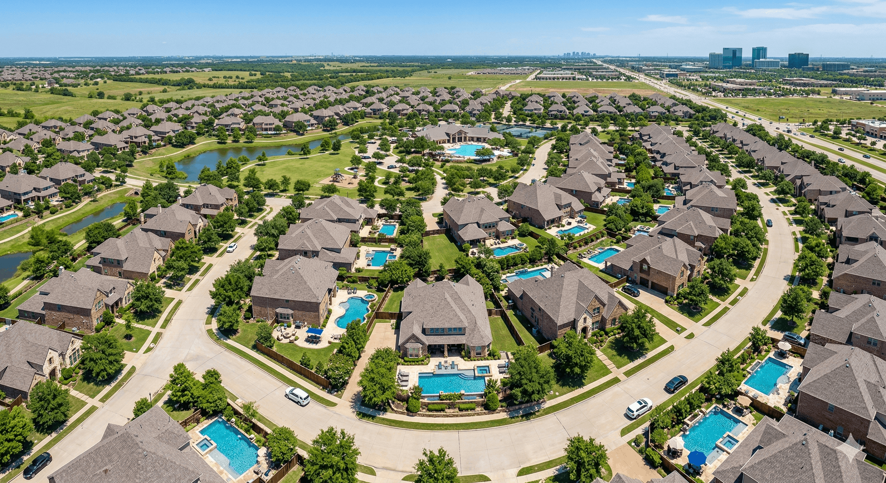 Overhead view of a master-planned community in Frisco, Texas, featuring large suburban homes, numerous private swimming pools, beautifully landscaped backyards, and tree-lined streets under a clear blue sky.